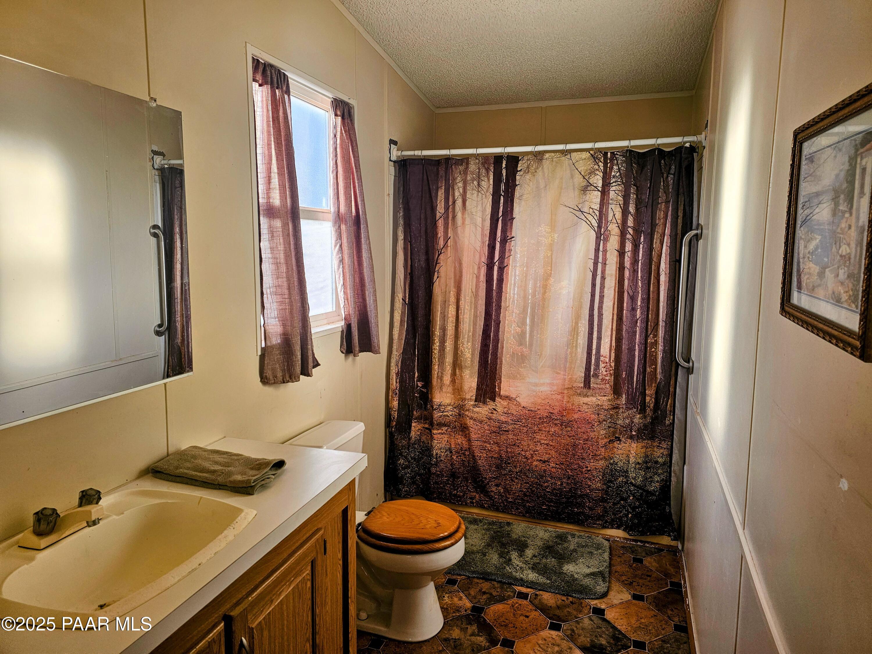 16225 North 29th Street, Unit 26 Phoenix, AZ 85032 - Photo 9 of 12 a bathroom with a sink toilet and shower
