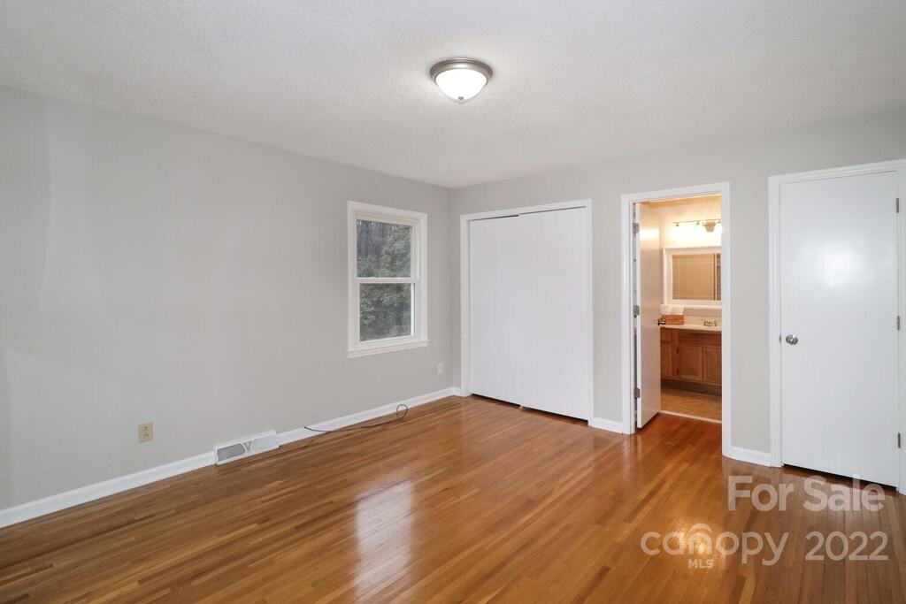 408 Ashbrook Road Salisbury, NC 28147 - Photo 17 of 48 an empty room with wooden floor and windows
