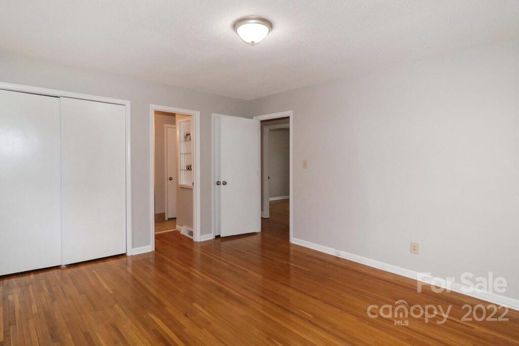 408 Ashbrook Road Salisbury, NC 28147 - Photo 18 of 48 a view of an empty room with wooden floor and closet