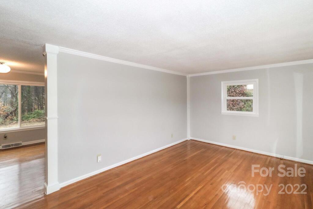 408 Ashbrook Road Salisbury, NC 28147 - Photo 7 of 48 an empty room with wooden floor and windows