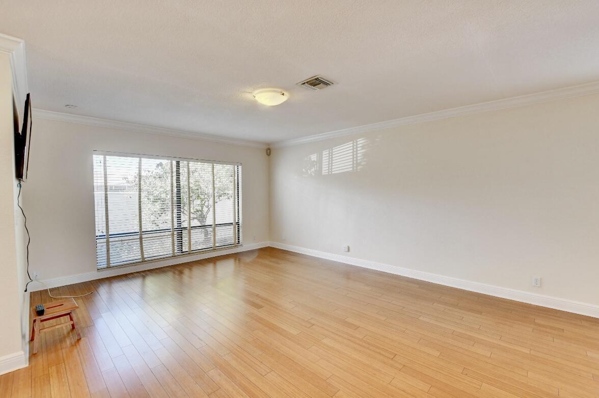 17768 Maplewood Drive Boca Raton, FL 33487 - Photo 11 of 50 a view of an empty room with wooden floor and a window