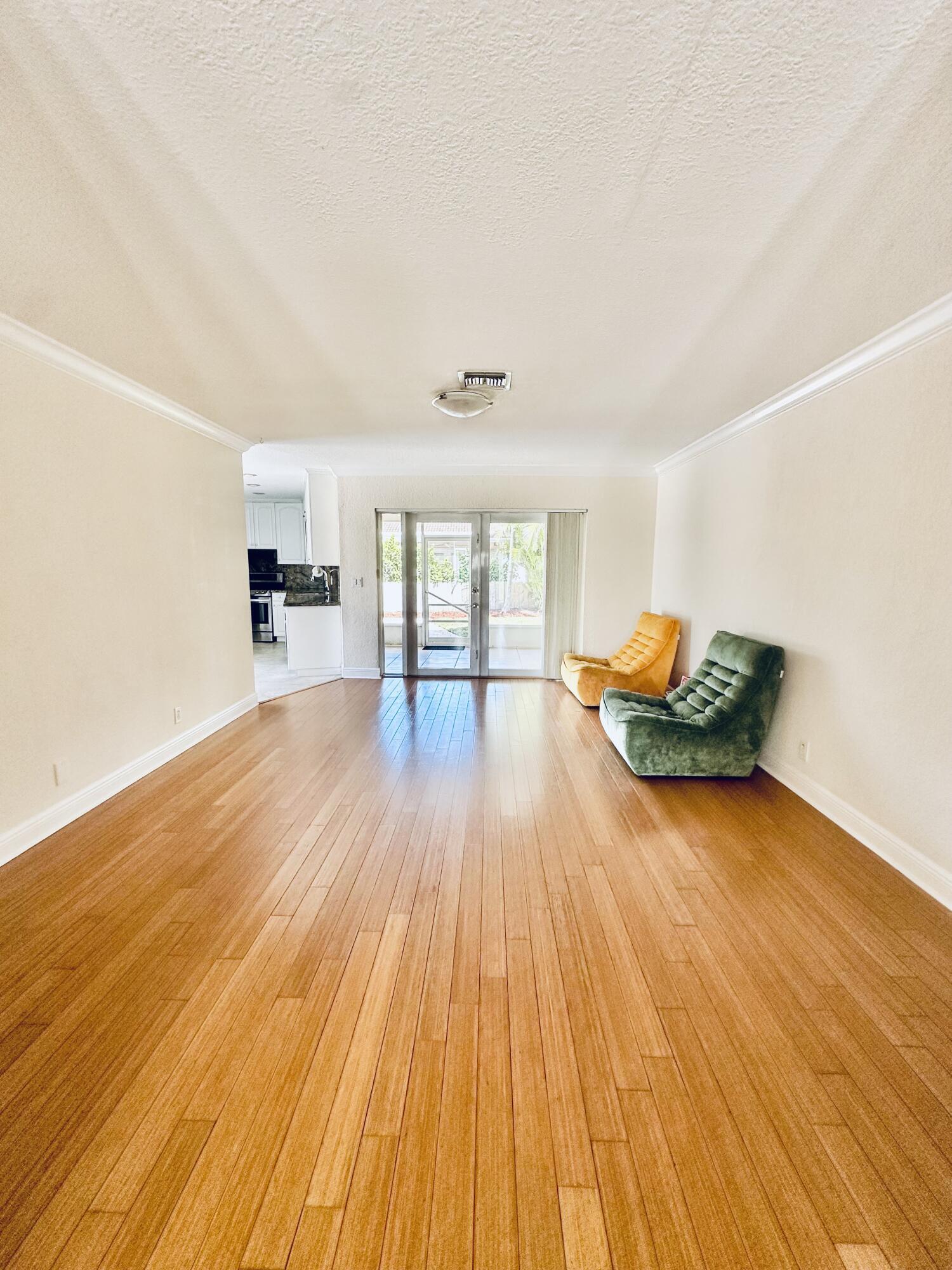 17768 Maplewood Drive Boca Raton, FL 33487 - Photo 14 of 50 a big room with wooden floors and natural light