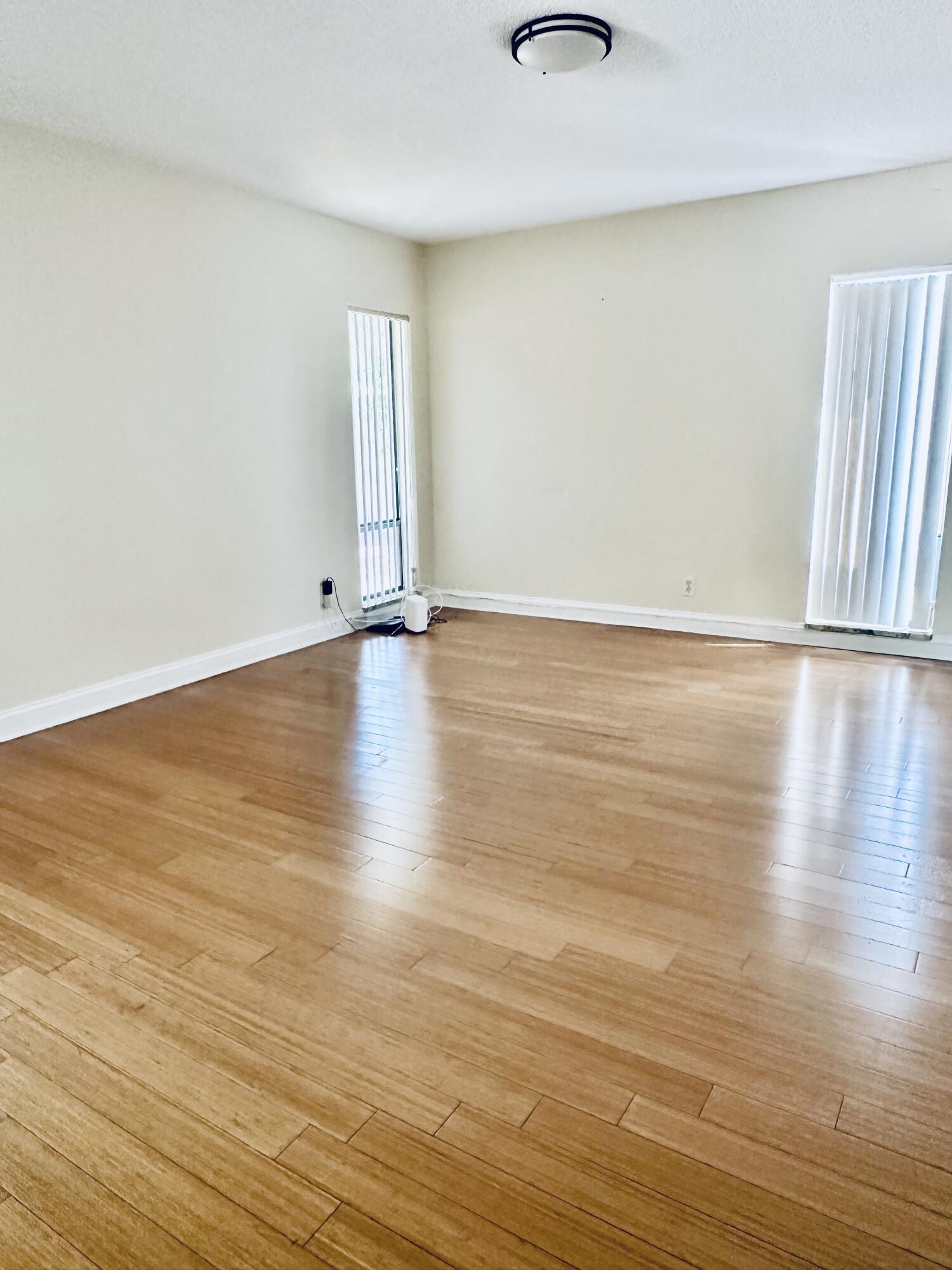 17768 Maplewood Drive Boca Raton, FL 33487 - Photo 19 of 50 a view of an empty room with wooden floor