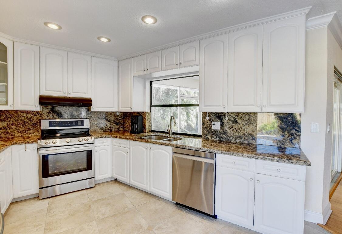17768 Maplewood Drive Boca Raton, FL 33487 - Photo 23 of 50 a kitchen with white cabinets appliances and sink