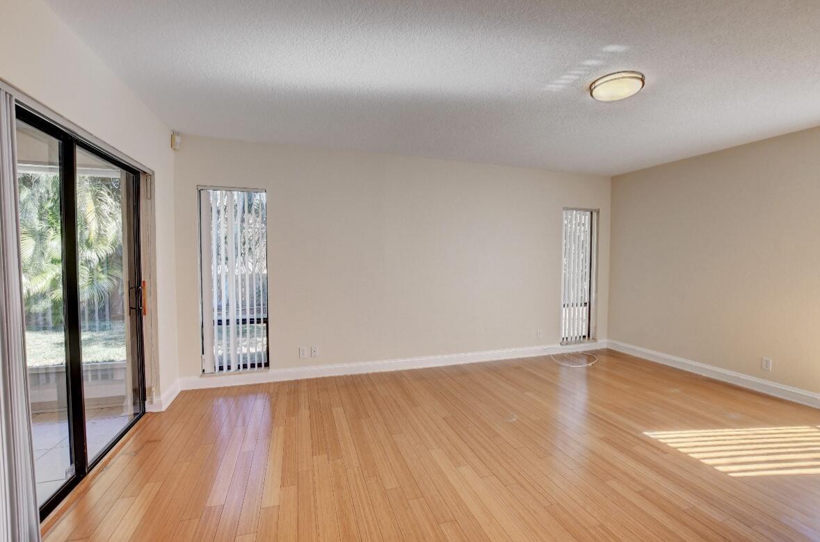 17768 Maplewood Drive Boca Raton, FL 33487 - Photo 26 of 50 wooden floor in an empty room with a window