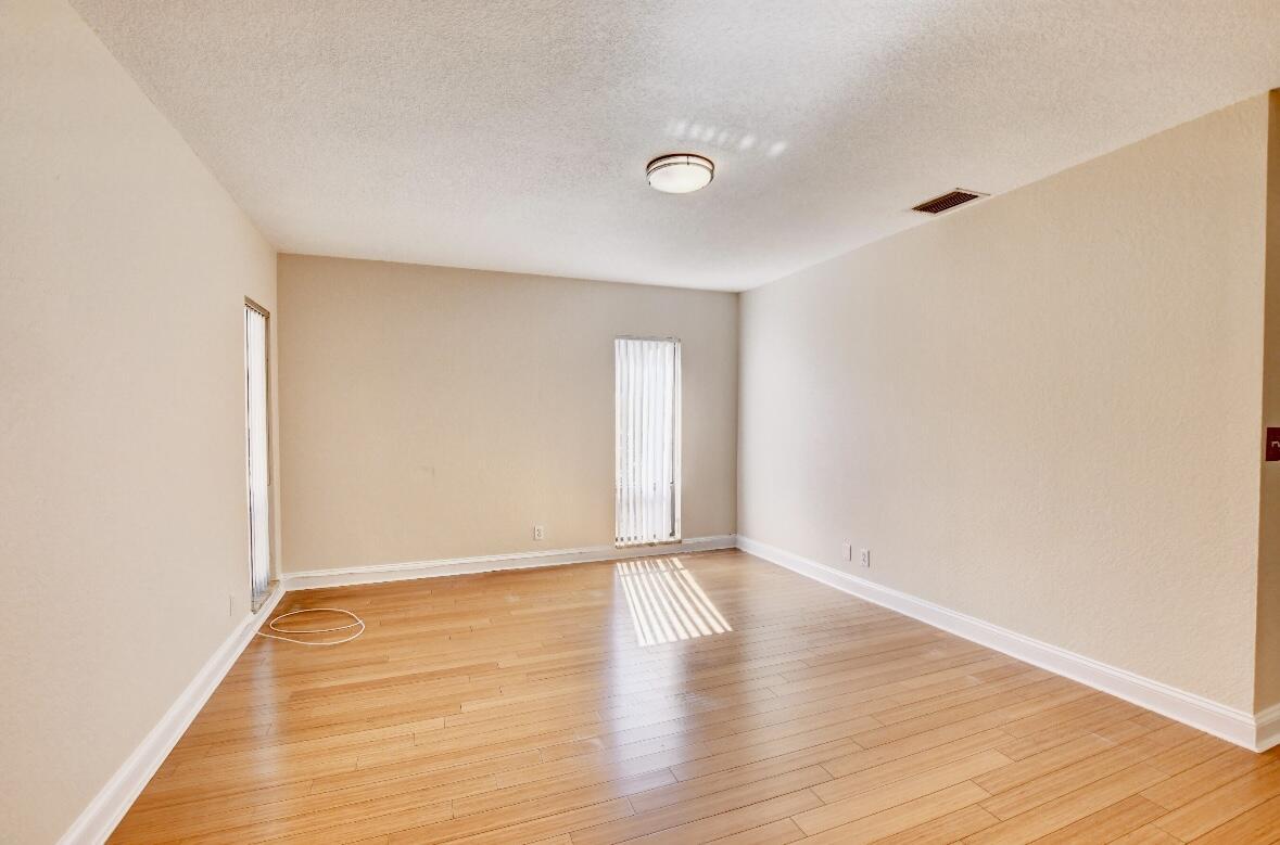 17768 Maplewood Drive Boca Raton, FL 33487 - Photo 27 of 50 a view of an empty room with wooden floor and a window