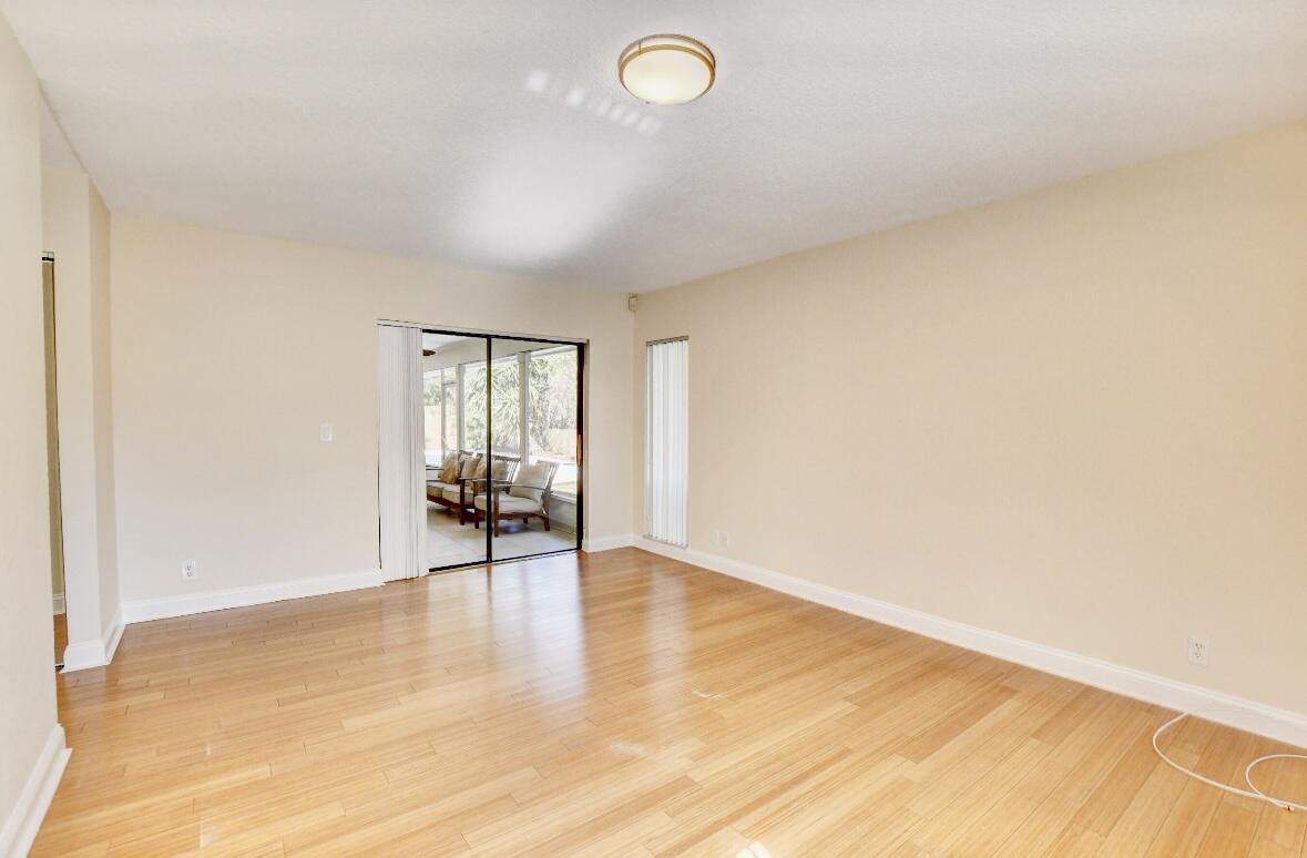 17768 Maplewood Drive Boca Raton, FL 33487 - Photo 28 of 50 a view of empty room with wooden floor and fan