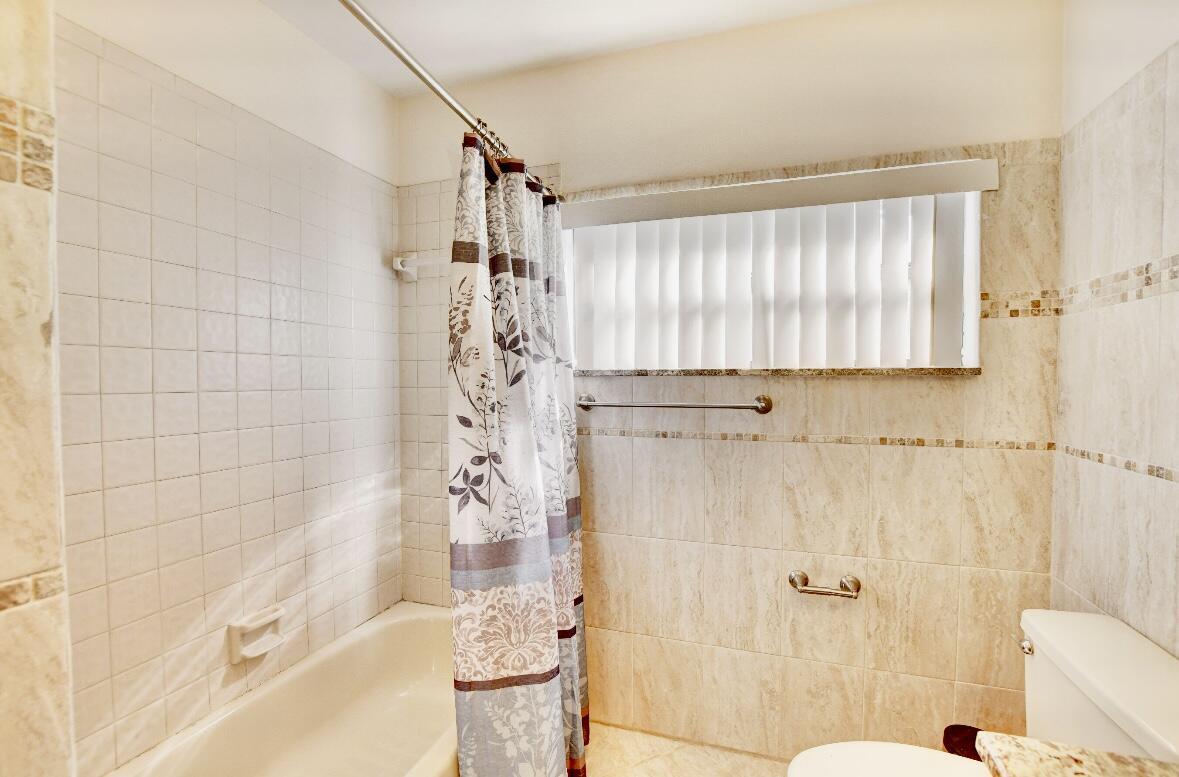 17768 Maplewood Drive Boca Raton, FL 33487 - Photo 33 of 50 a bathroom with a shower and a toilet