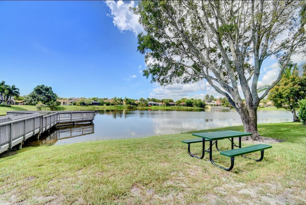17768 Maplewood Drive Boca Raton, FL 33487 - Photo 48 of 50 a view of a lake with couches and wooden fence