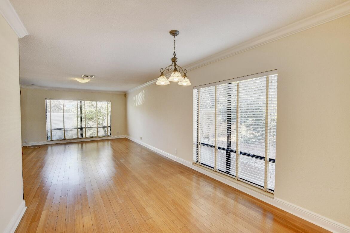 17768 Maplewood Drive Boca Raton, FL 33487 - Photo 6 of 50 a view of a room with wooden floor and windows
