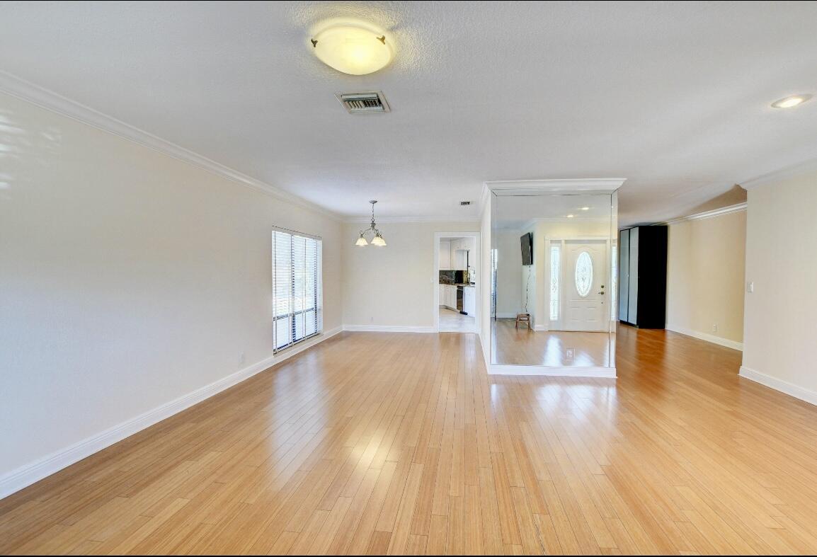 17768 Maplewood Drive Boca Raton, FL 33487 - Photo 7 of 50 a view of an empty room and wooden floor