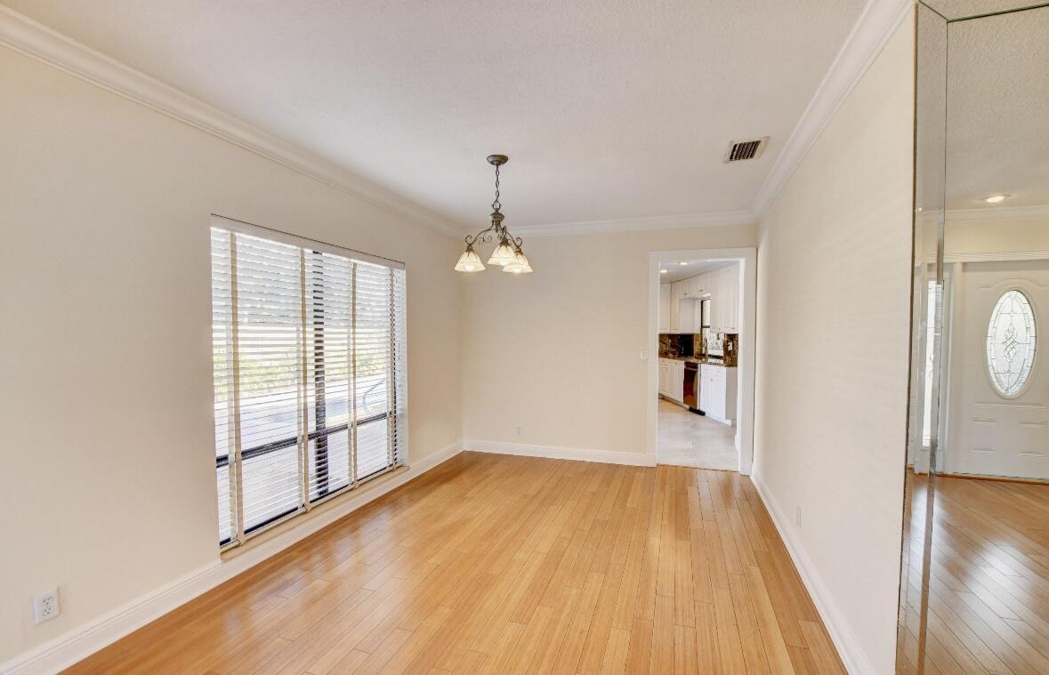 17768 Maplewood Drive Boca Raton, FL 33487 - Photo 8 of 50 wooden floor in an empty room with a window