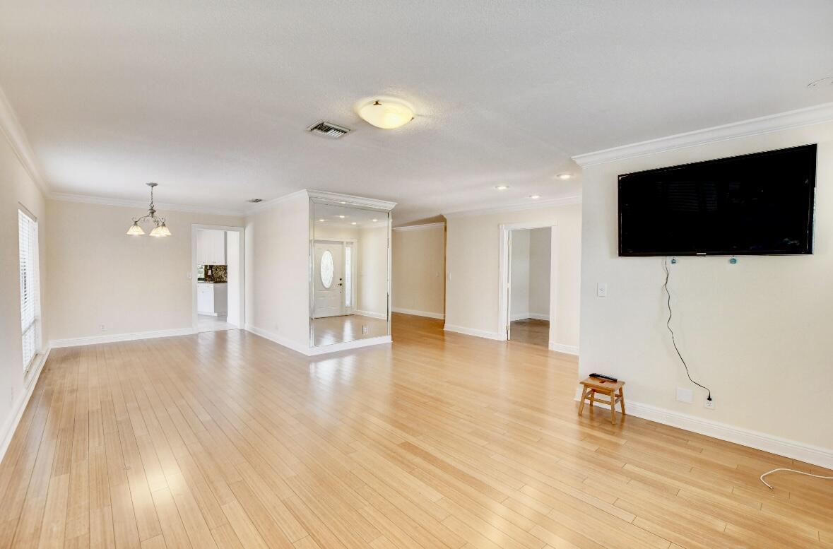 17768 Maplewood Drive Boca Raton, FL 33487 - Photo 9 of 50 a view of a livingroom with wooden floor and a flat screen tv