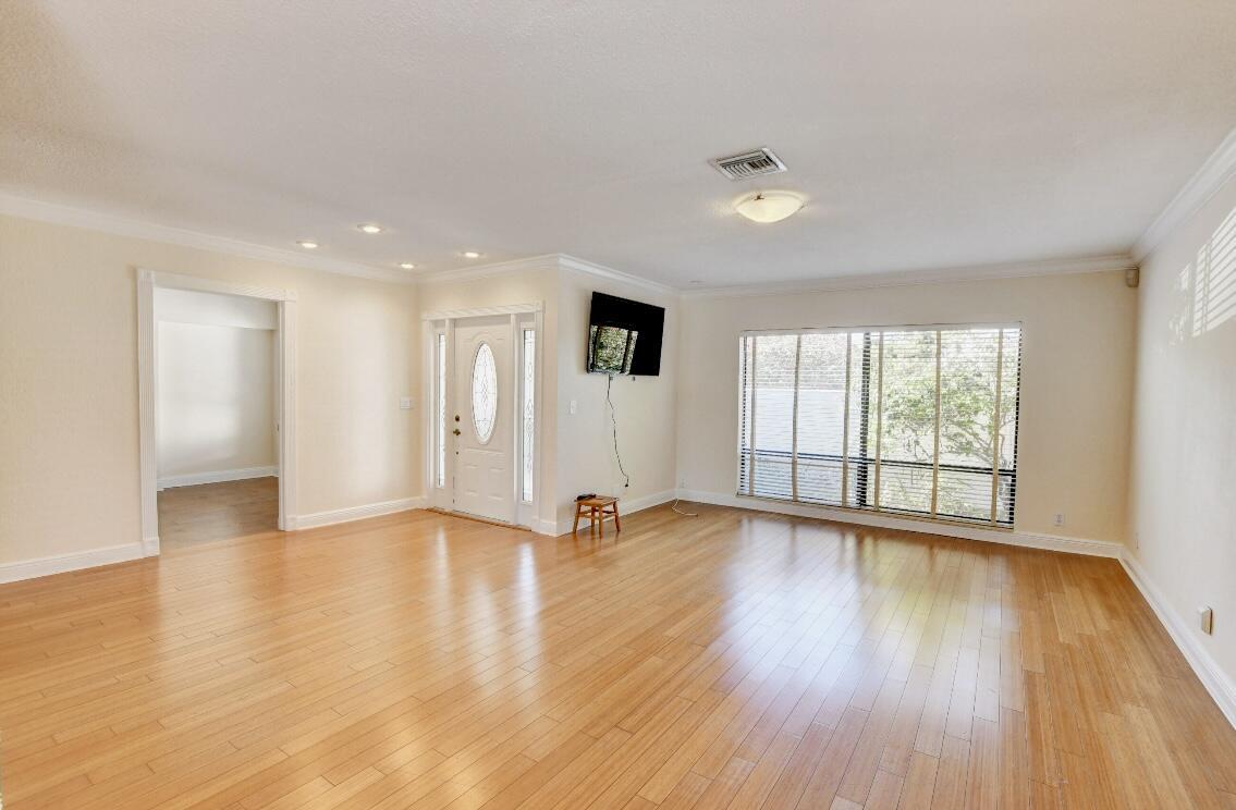 17768 Maplewood Drive Boca Raton, FL 33487 - Photo 10 of 50 a view of an empty room with wooden floor and a window