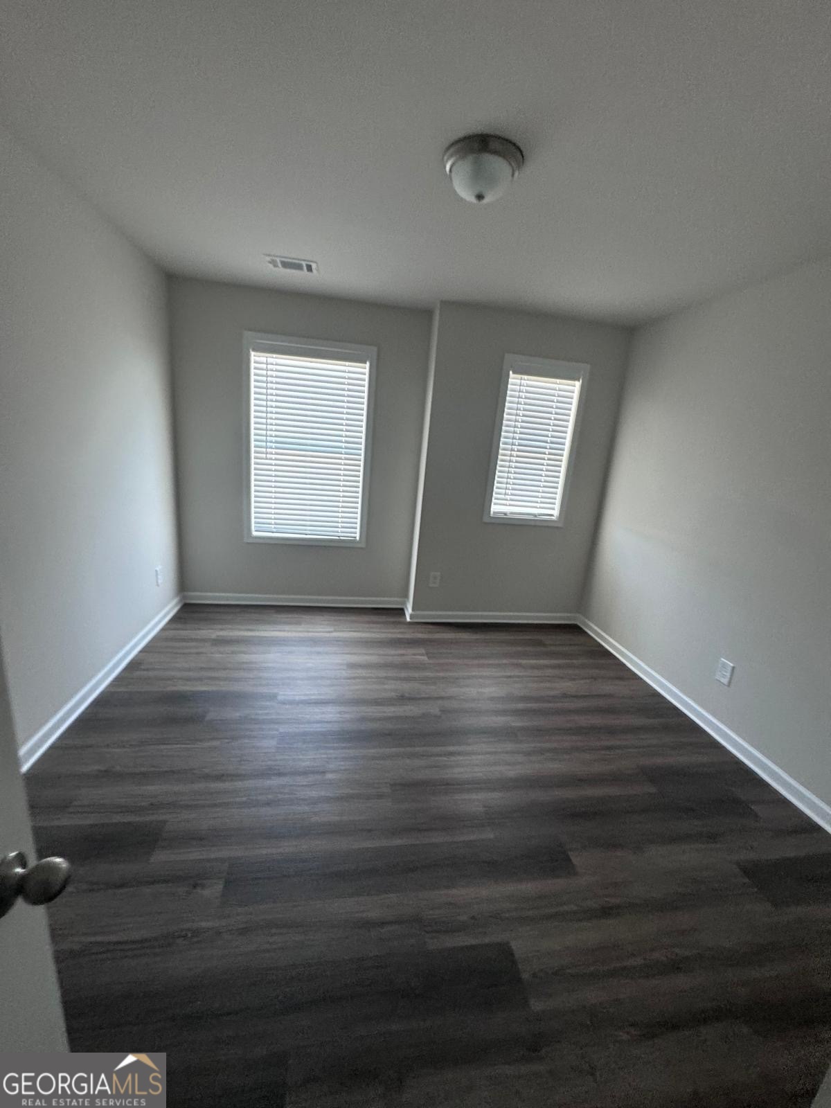 855 Pensive Run Dacula, GA 30019 - Photo 4 of 8 an empty room with wooden floor and windows