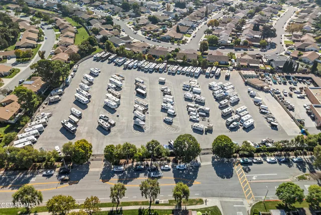 a view of a patio with a dining table and chairs with a fire pit
