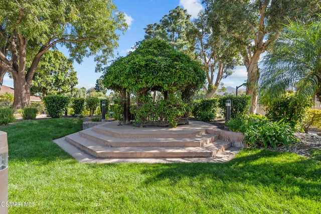 a dining room with furniture and a floor to ceiling window