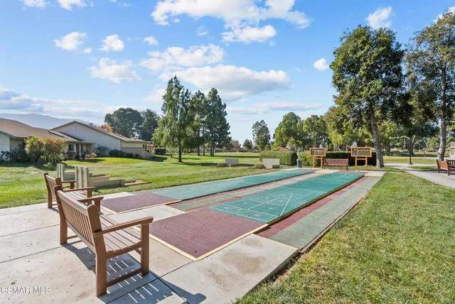 a living room with a pool table and a fireplace