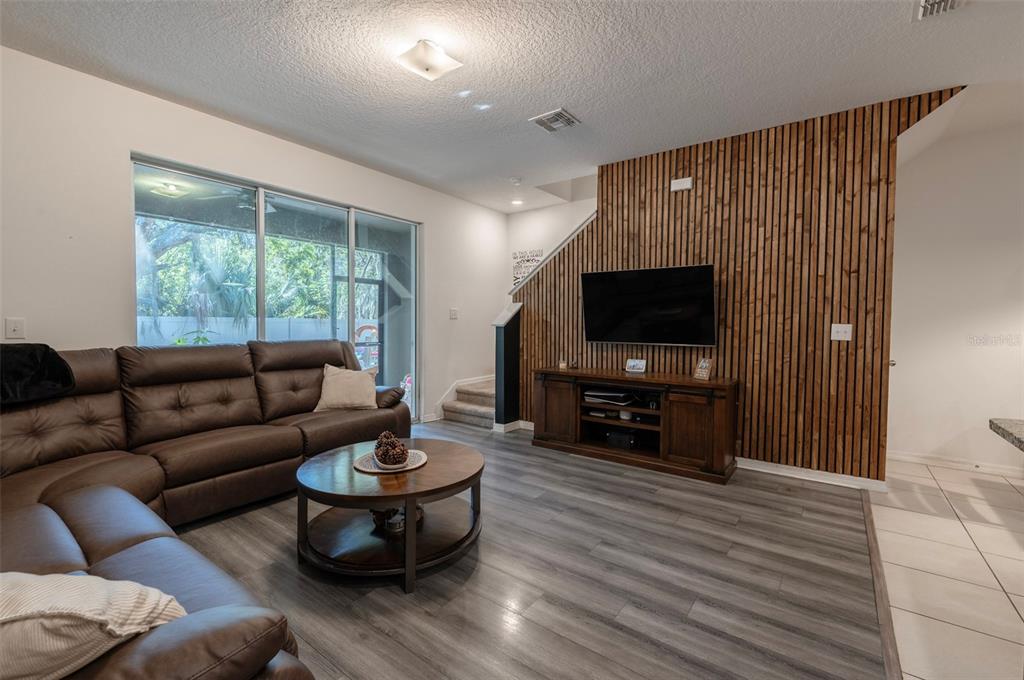 3327 Pleasant Willow Court Brandon, FL 33511 - Photo 13 of 28 a living room with furniture a flat screen tv and a large window