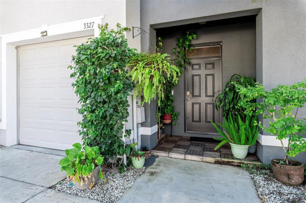 3327 Pleasant Willow Court Brandon, FL 33511 - Photo 2 of 28 a house with potted plants in front of it