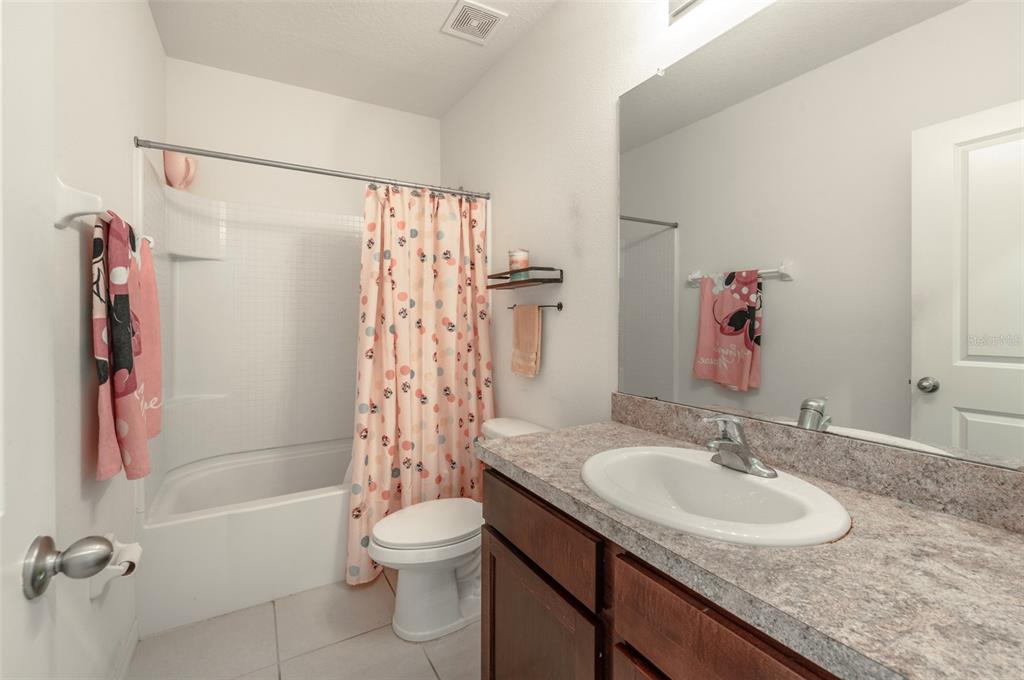 3327 Pleasant Willow Court Brandon, FL 33511 - Photo 23 of 28 a bathroom with a granite countertop sink toilet and shower