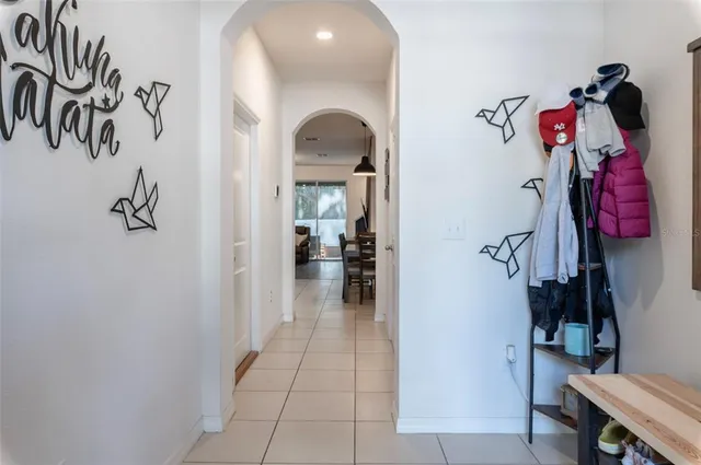 a view of a hallway with closet and a rug
