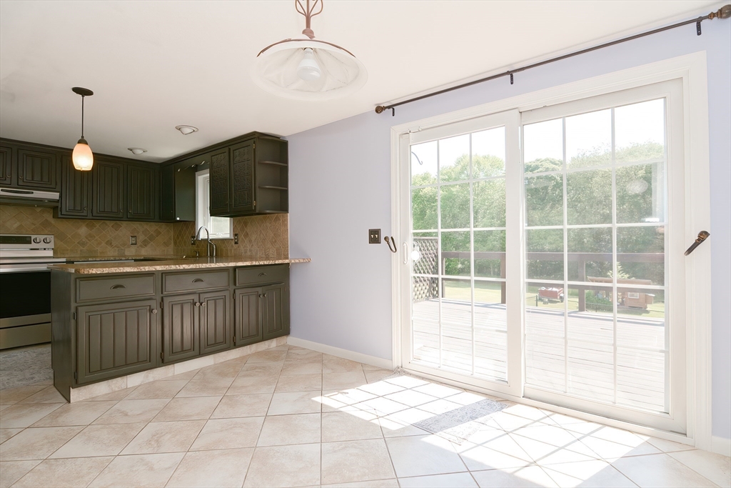 633 Williams Street Dighton, MA 02764 - Photo 14 of 41 a open kitchen with kitchen island granite countertop a sink and a stove top oven