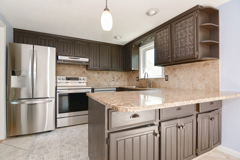 633 Williams Street Dighton, MA 02764 - Photo 16 of 41 a kitchen with stainless steel appliances granite countertop a refrigerator sink and cabinets