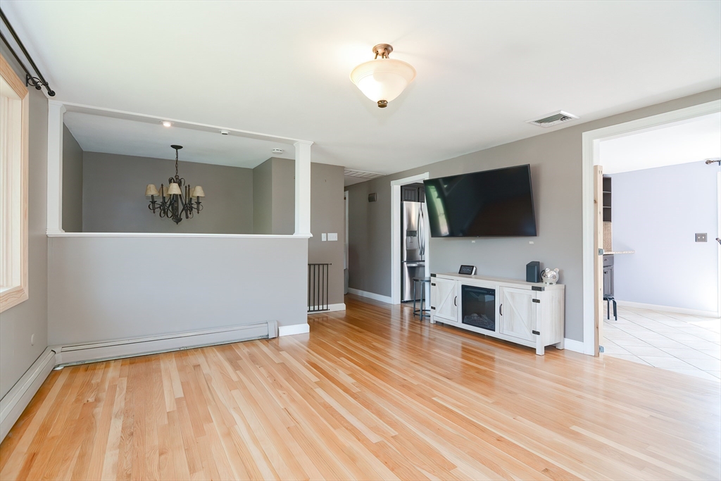 633 Williams Street Dighton, MA 02764 - Photo 10 of 41 wooden floor in kitchen and a livingroom with an empty space