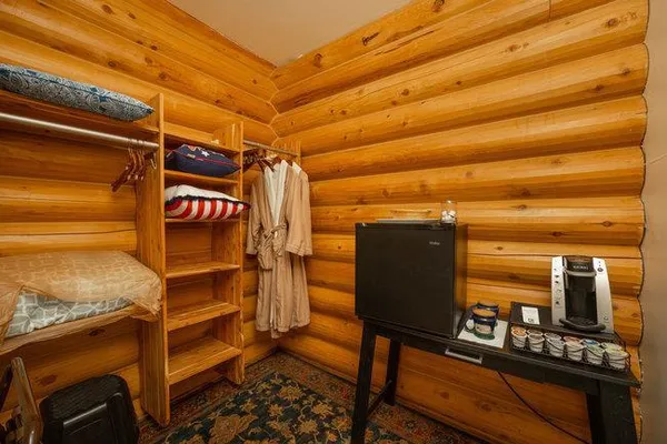 a bedroom with a bed and a flat tv screen on dresser