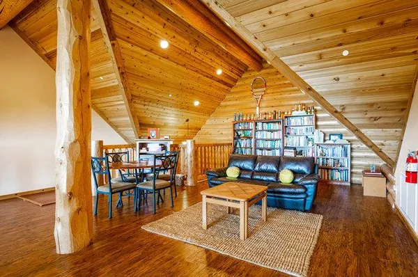 a bedroom with a bed and painting on the wall