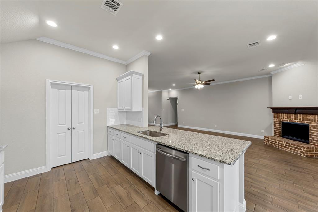 18310 Chippewa Court Terrell, TX 75160 - Photo 11 of 35 a kitchen with a sink chandelier and wooden floor