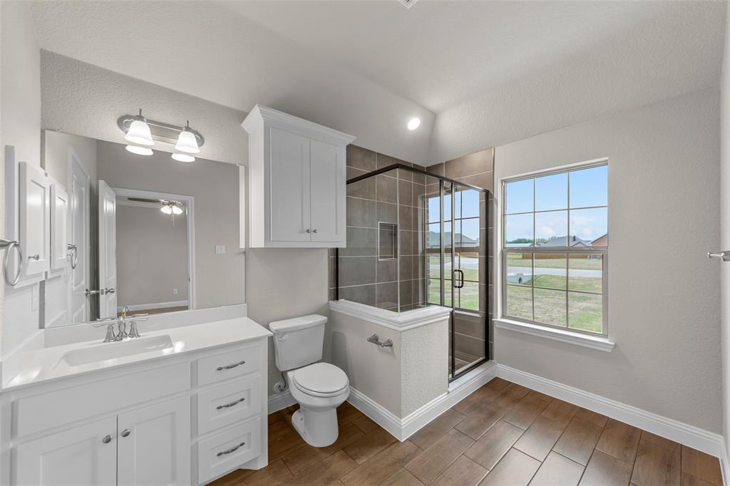 18310 Chippewa Court Terrell, TX 75160 - Photo 18 of 35 a bathroom with a double vanity sink toilet and shower