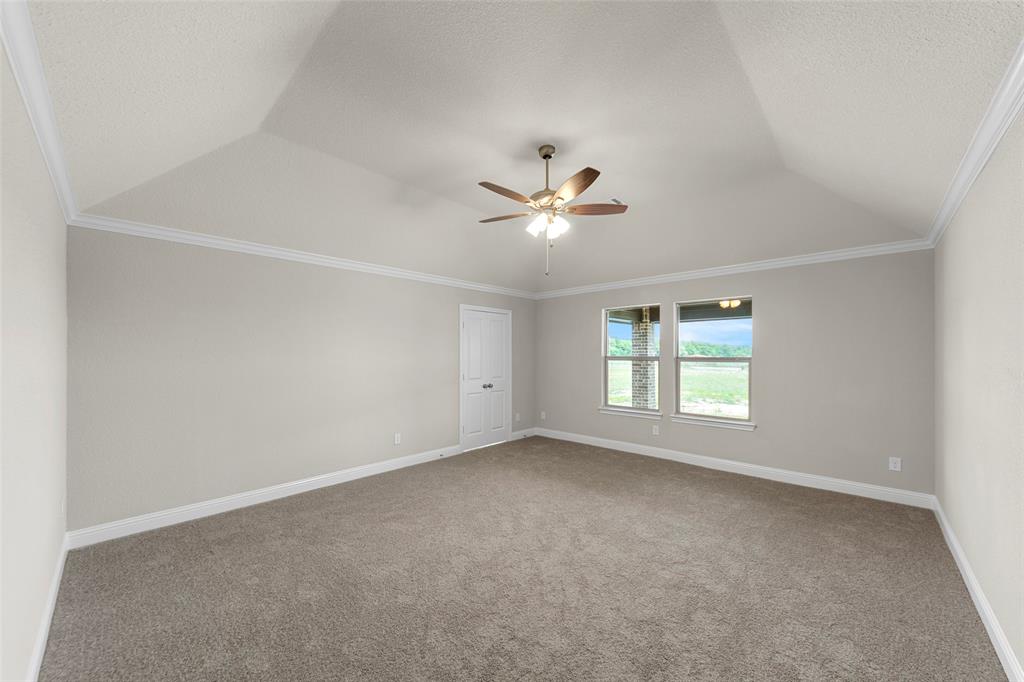 18310 Chippewa Court Terrell, TX 75160 - Photo 21 of 35 an empty room with windows and ceiling fan