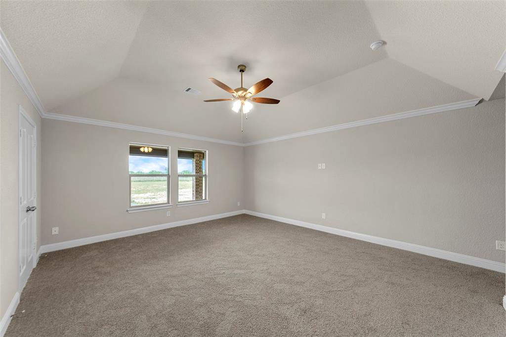 18310 Chippewa Court Terrell, TX 75160 - Photo 22 of 35 an empty room with windows and chandelier fan