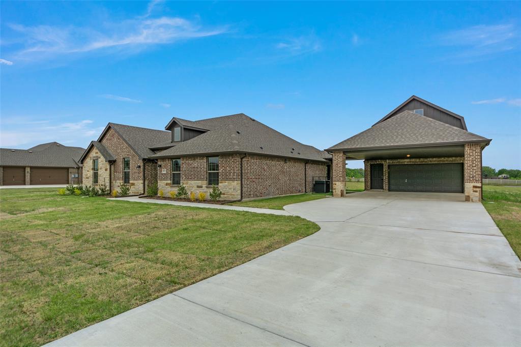 18310 Chippewa Court Terrell, TX 75160 - Photo 3 of 35 a front view of a house with a garden