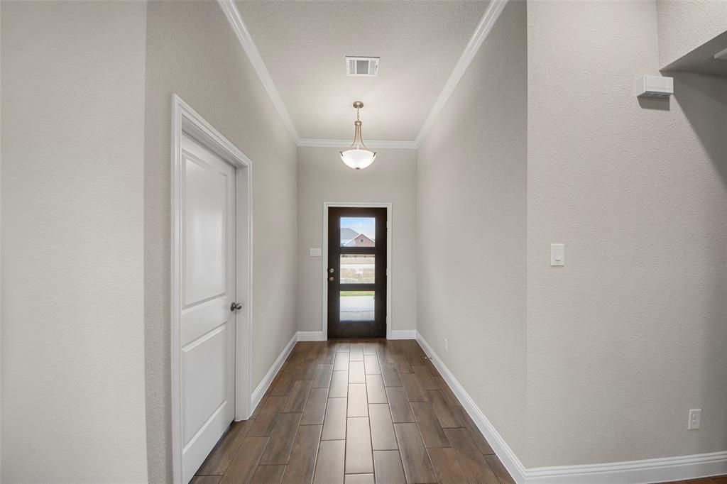 18310 Chippewa Court Terrell, TX 75160 - Photo 4 of 35 wooden floor in a gallery with a chandelier fan