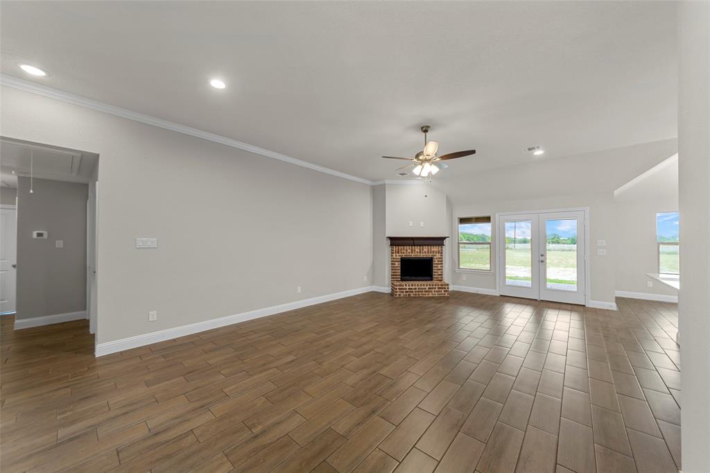18310 Chippewa Court Terrell, TX 75160 - Photo 5 of 35 a view of an empty room with wooden floor and a window