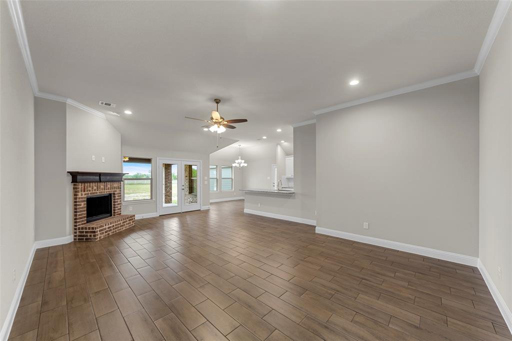 18310 Chippewa Court Terrell, TX 75160 - Photo 6 of 35 a view of empty room with wooden floor and fireplace