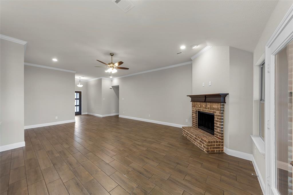 18310 Chippewa Court Terrell, TX 75160 - Photo 7 of 35 a view of an empty room with wooden floor fireplace and a window