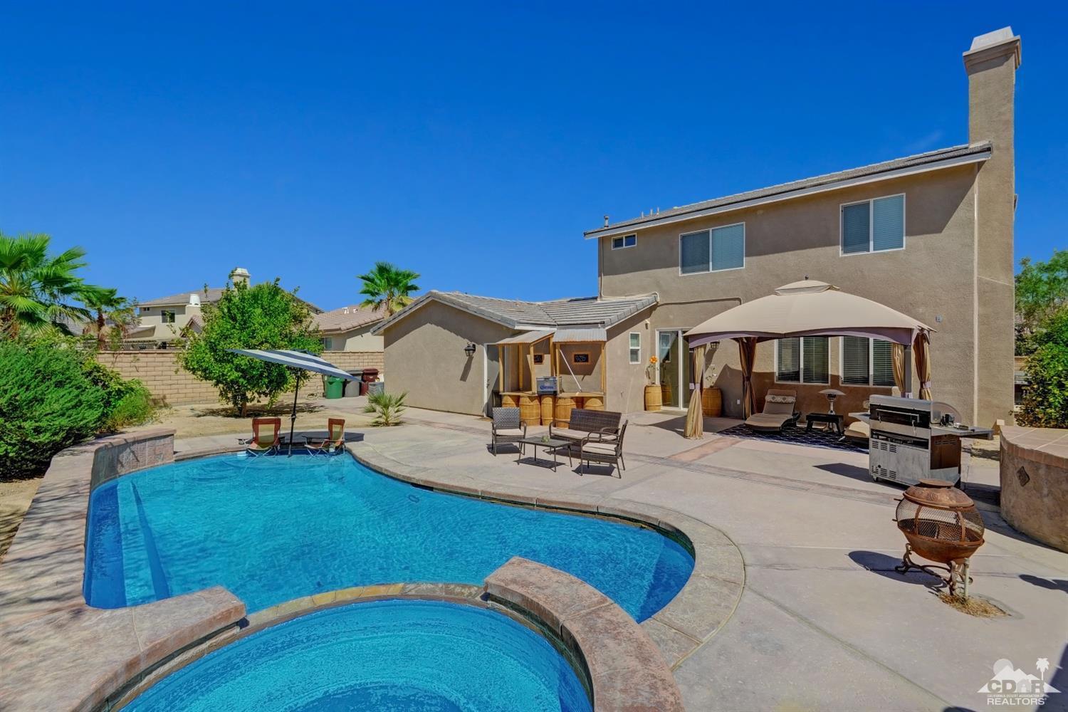 37773 Caprice Drive Indio, CA 92203 - Photo 1 of 26 a view of a house with swimming pool patio and sitting area