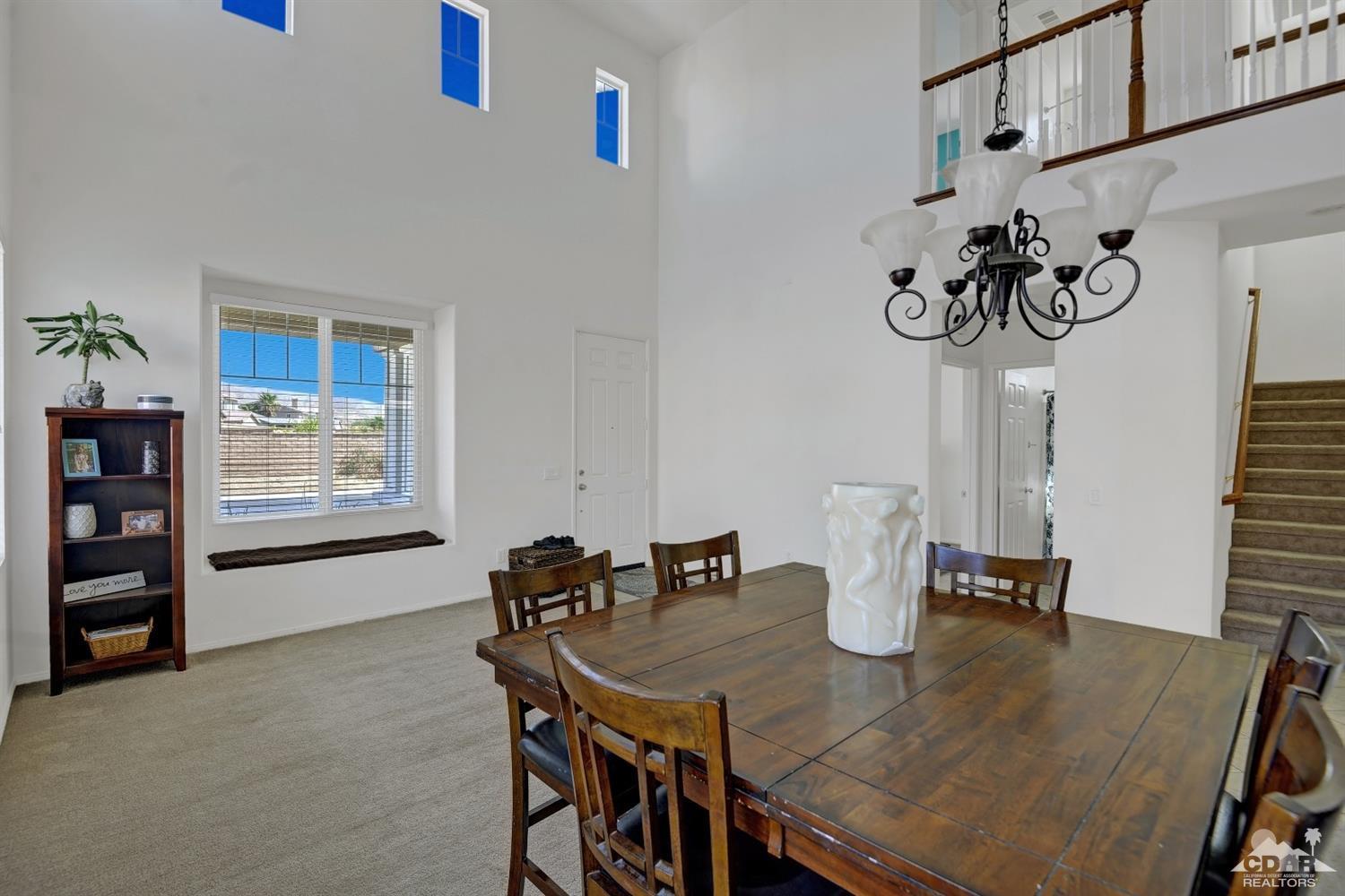 37773 Caprice Drive Indio, CA 92203 - Photo 11 of 26 a view of a dining room with furniture and wooden floor