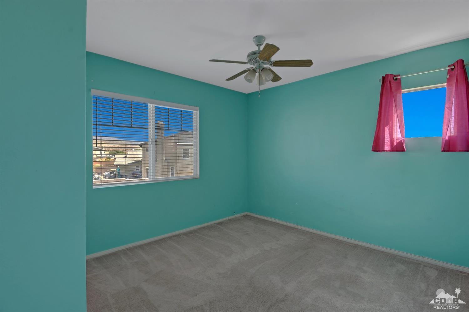 37773 Caprice Drive Indio, CA 92203 - Photo 19 of 26 a view of a room that has a bed and a fan