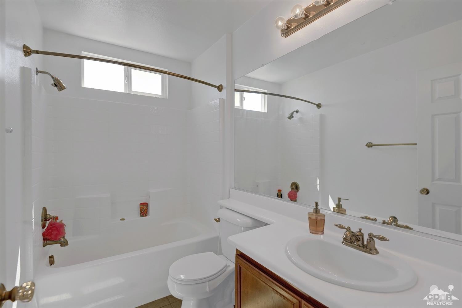 37773 Caprice Drive Indio, CA 92203 - Photo 20 of 26 a bathroom with a sink toilet and shower