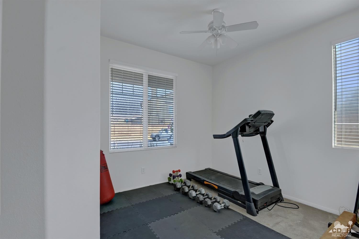 37773 Caprice Drive Indio, CA 92203 - Photo 21 of 26 a room with gym equipment and windows
