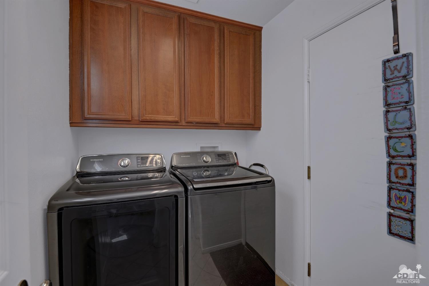 37773 Caprice Drive Indio, CA 92203 - Photo 22 of 26 a view of storage and utility room with washer and dryer