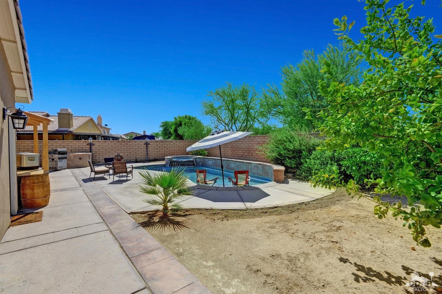 37773 Caprice Drive Indio, CA 92203 - Photo 23 of 26 a view of a chairs and table in the backyard