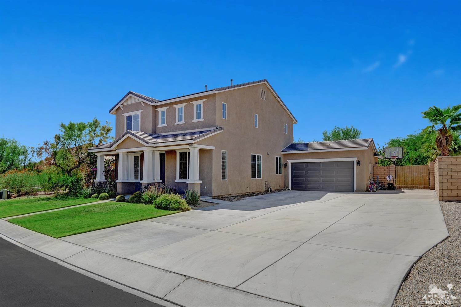 37773 Caprice Drive Indio, CA 92203 - Photo 6 of 26 a front view of a house with a yard and garage