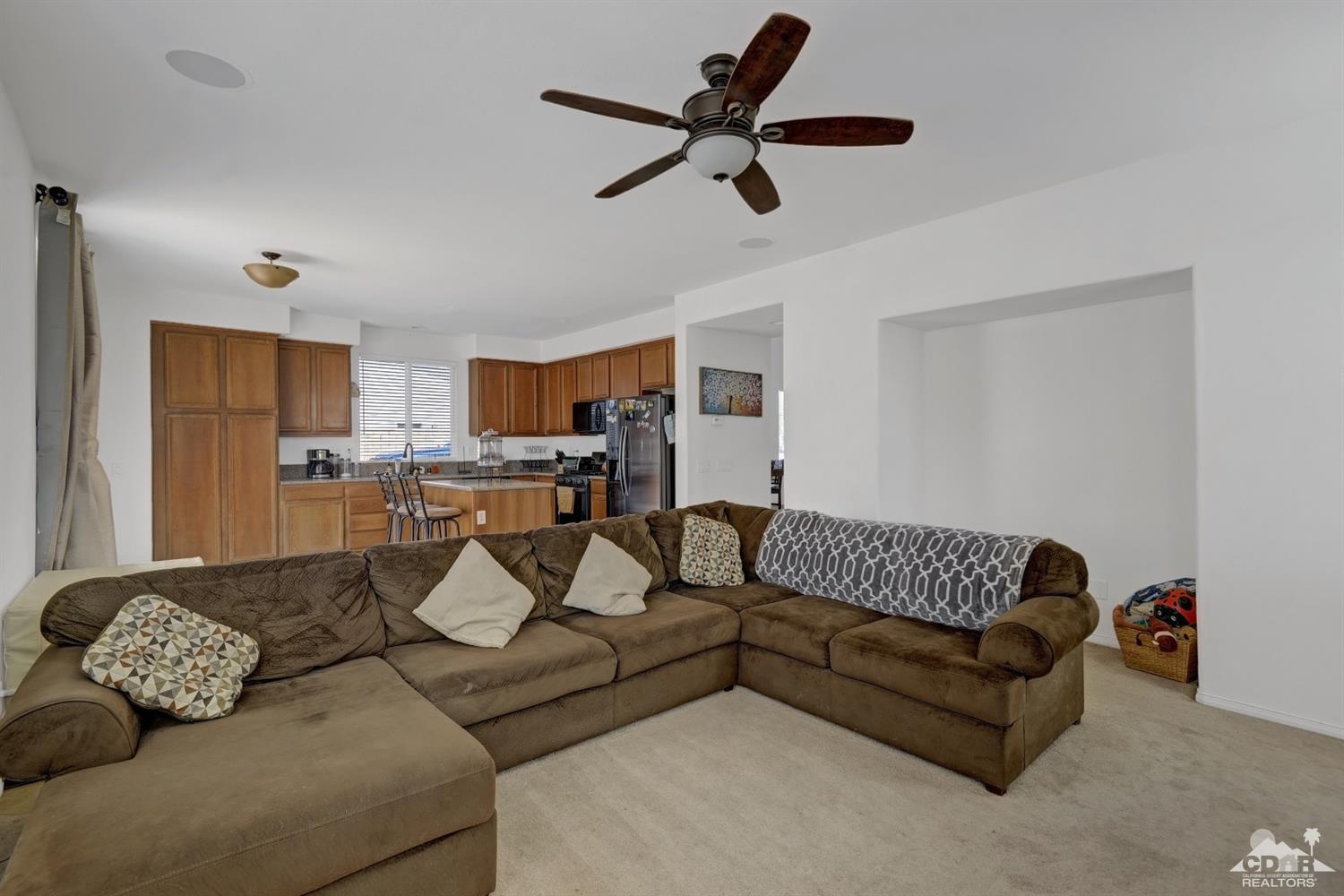 37773 Caprice Drive Indio, CA 92203 - Photo 10 of 26 a living room with furniture and kitchen view