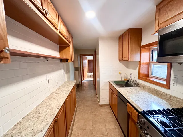 a kitchen with granite countertop lots of counter top space and stainless steel appliances